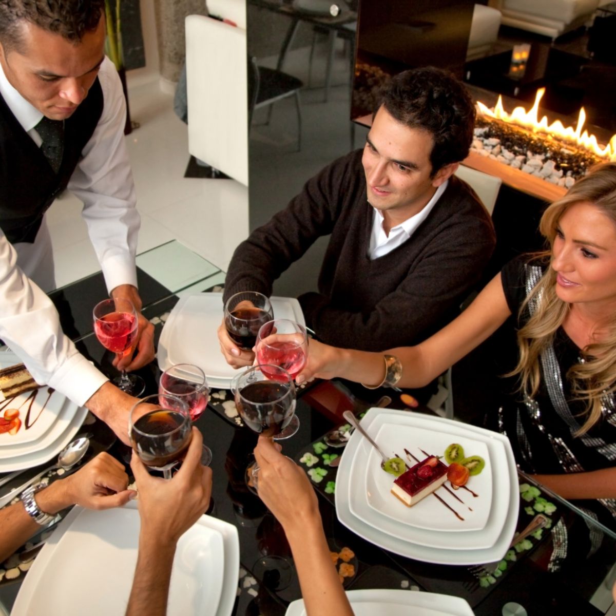THEbag A group of colleagues sharing wine over a lavish dinner